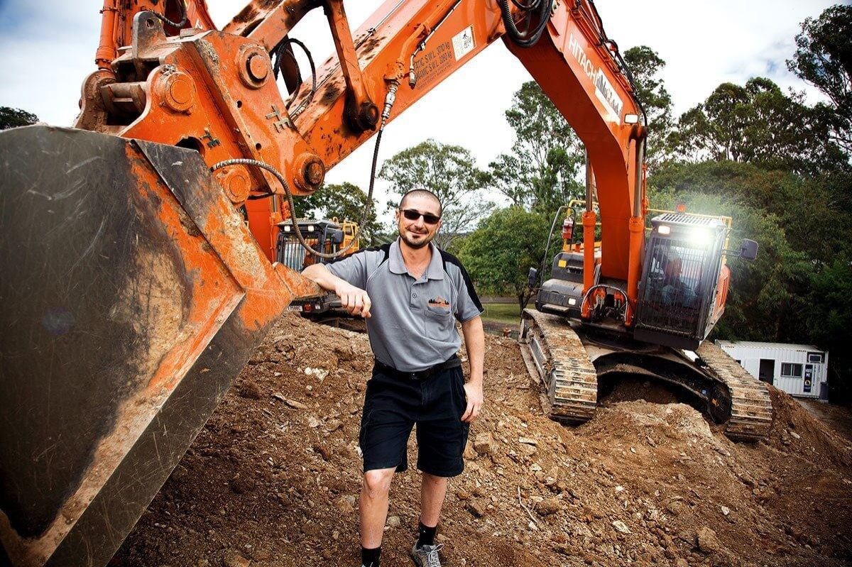 The founder of Urban Demolition, Vince Cubito, leaning on an excavator